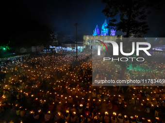 Devotees offer prayers by lighting oil lamps and incense sticks to Sri Loknath Brahmachari on the occasion of Karthik Brata at a Loknath Bra...