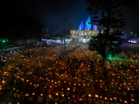 Devotees offer prayers by lighting oil lamps and incense sticks to Sri Loknath Brahmachari on the occasion of Karthik Brata at a Loknath Bra...