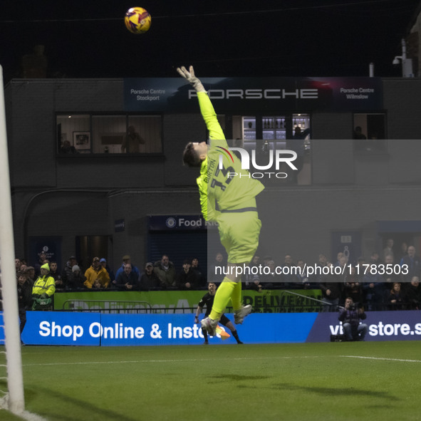 Callum Burton #13 (GK) of Wrexham A.F.C. makes a save during the Sky Bet League 1 match between Stockport County and Wrexham at the Edgeley...