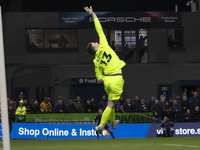 Callum Burton #13 (GK) of Wrexham A.F.C. makes a save during the Sky Bet League 1 match between Stockport County and Wrexham at the Edgeley...