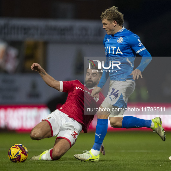 Lewis Brunt #3 of Wrexham A.F.C. challenges Will Collar #14 of Stockport County F.C. during the Sky Bet League 1 match between Stockport Cou...