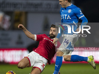 Lewis Brunt #3 of Wrexham A.F.C. challenges Will Collar #14 of Stockport County F.C. during the Sky Bet League 1 match between Stockport Cou...