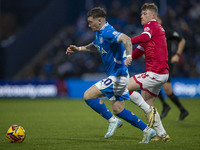 Louie Barry #20 of Stockport County F.C. is challenged by Andy Cannon #8 of Wrexham A.F.C. during the Sky Bet League 1 match between Stockpo...