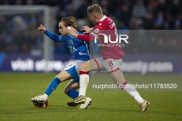 Lewis Bate #4 of Stockport County F.C. is challenged by Andy Cannon #8 of Wrexham A.F.C. during the Sky Bet League 1 match between Stockport...