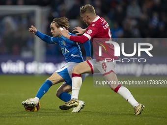 Lewis Bate #4 of Stockport County F.C. is challenged by Andy Cannon #8 of Wrexham A.F.C. during the Sky Bet League 1 match between Stockport...