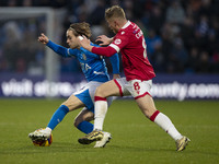 Lewis Bate #4 of Stockport County F.C. is challenged by Andy Cannon #8 of Wrexham A.F.C. during the Sky Bet League 1 match between Stockport...