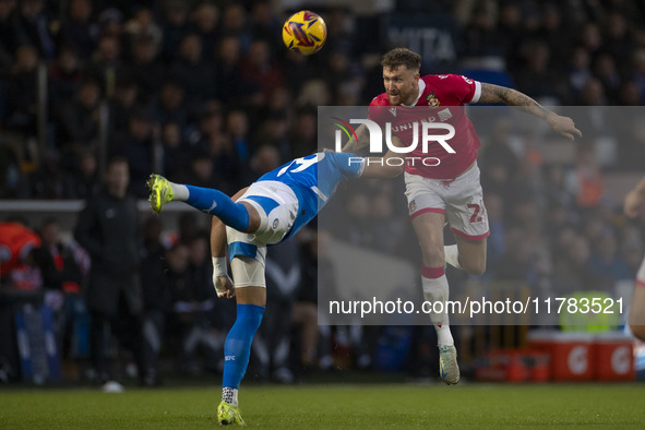 Dan Scarr, number 24 of Wrexham A.F.C., heads the ball during the Sky Bet League 1 match between Stockport County and Wrexham at the Edgeley...