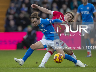 Lewis Bate #4 of Stockport County F.C. is challenged by the opponent during the Sky Bet League 1 match between Stockport County and Wrexham...