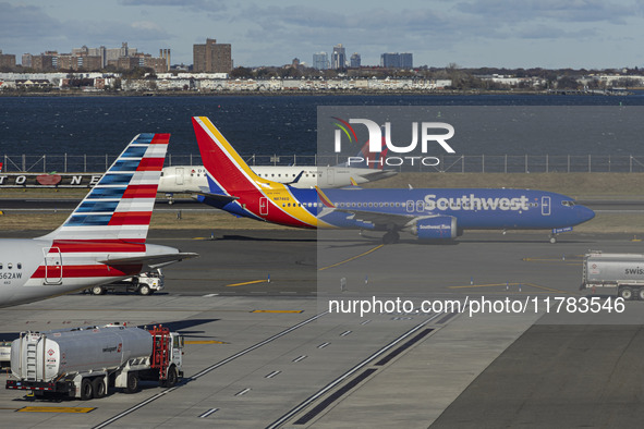 Southwest Airlines Boeing 737 MAX 8 airplane with registration tail number N8746Q spotted taxiing in LaGuardia Airport next to American Airl...