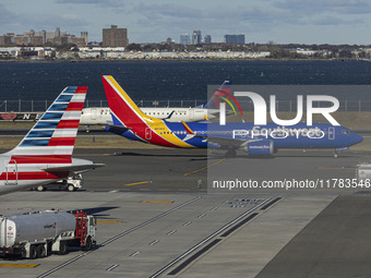 Southwest Airlines Boeing 737 MAX 8 airplane with registration tail number N8746Q spotted taxiing in LaGuardia Airport next to American Airl...