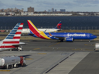 Southwest Airlines Boeing 737 MAX 8 airplane with registration tail number N8746Q spotted taxiing in LaGuardia Airport next to American Airl...