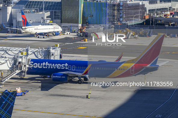 Southwest Airlines Boeing 737-800 airplane with registration tail number N8617E spotted parked and docked with a jet bridge in LaGuardia Air...