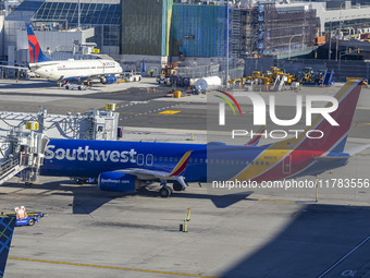 Southwest Airlines Boeing 737-800 airplane with registration tail number N8617E spotted parked and docked with a jet bridge in LaGuardia Air...