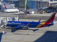 Southwest Airlines Boeing 737-800 airplane with registration tail number N8617E spotted parked and docked with a jet bridge in LaGuardia Air...