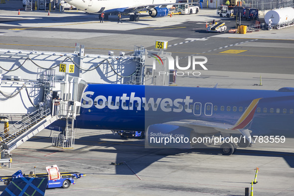 Southwest Airlines Boeing 737-800 airplane with registration tail number N8617E spotted parked and docked with a jet bridge in LaGuardia Air...