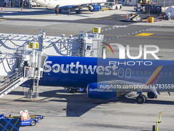 Southwest Airlines Boeing 737-800 airplane with registration tail number N8617E spotted parked and docked with a jet bridge in LaGuardia Air...