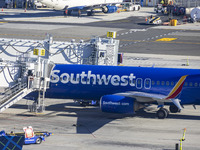 Southwest Airlines Boeing 737-800 airplane with registration tail number N8617E spotted parked and docked with a jet bridge in LaGuardia Air...