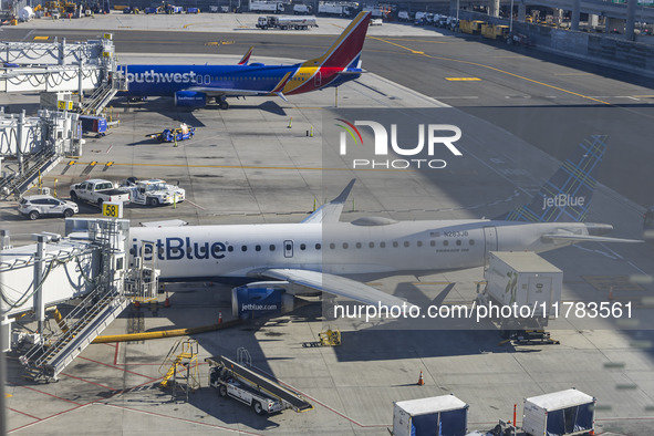 Southwest Airlines Boeing 737-800 airplane with tail number N8617E and a jetBlue Embraer E190 with registration N283JB spotted parked and do...