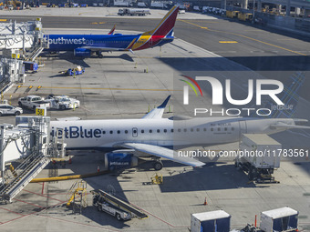 Southwest Airlines Boeing 737-800 airplane with tail number N8617E and a jetBlue Embraer E190 with registration N283JB spotted parked and do...