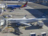 Southwest Airlines Boeing 737-800 airplane with tail number N8617E and a jetBlue Embraer E190 with registration N283JB spotted parked and do...