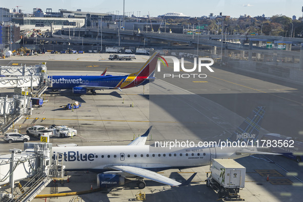 Southwest Airlines Boeing 737-800 airplane with tail number N8617E and a jetBlue Embraer E190 with registration N283JB spotted parked and do...