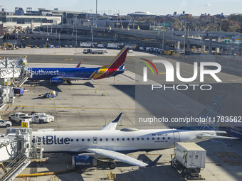 Southwest Airlines Boeing 737-800 airplane with tail number N8617E and a jetBlue Embraer E190 with registration N283JB spotted parked and do...