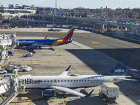 Southwest Airlines Boeing 737-800 airplane with tail number N8617E and a jetBlue Embraer E190 with registration N283JB spotted parked and do...