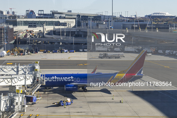 Southwest Airlines Boeing 737-800 airplane with registration tail number N8617E spotted parked and docked with a jet bridge in LaGuardia Air...