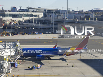 Southwest Airlines Boeing 737-800 airplane with registration tail number N8617E spotted parked and docked with a jet bridge in LaGuardia Air...