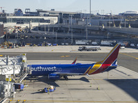 Southwest Airlines Boeing 737-800 airplane with registration tail number N8617E spotted parked and docked with a jet bridge in LaGuardia Air...