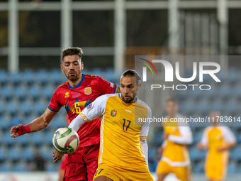 Christian Gonzalez of Andorra and Victor Mudrac of Moldova compete for the ball during the UEFA Nations League 2024 - League phase - Matchda...