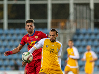 Christian Gonzalez of Andorra and Victor Mudrac of Moldova compete for the ball during the UEFA Nations League 2024 - League phase - Matchda...