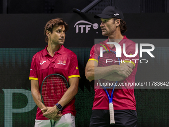 In Malaga, Spain, on November 16, 2024, Carlos Moya of Spain and David Ferrer, captain of Spain, participate in a training session in prepar...