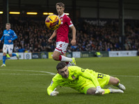 Callum Burton #13 (GK) of Wrexham A.F.C. makes a save during the Sky Bet League 1 match between Stockport County and Wrexham at the Edgeley...