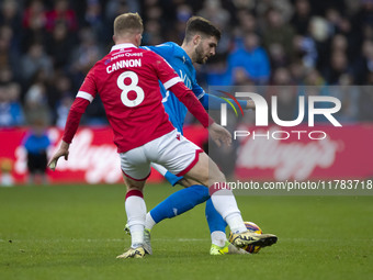 Ethan Pye #15 of Stockport County F.C. is challenged by Andy Cannon #8 of Wrexham A.F.C. during the Sky Bet League 1 match between Stockport...