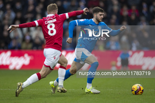 Ethan Pye #15 of Stockport County F.C. is challenged by Andy Cannon #8 of Wrexham A.F.C. during the Sky Bet League 1 match between Stockport...