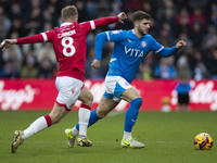 Ethan Pye #15 of Stockport County F.C. is challenged by Andy Cannon #8 of Wrexham A.F.C. during the Sky Bet League 1 match between Stockport...