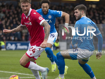 Dan Scarr #24 of Wrexham A.F.C. is challenged by Ethan Pye #15 of Stockport County F.C. during the Sky Bet League 1 match between Stockport...