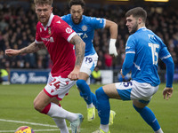 Dan Scarr #24 of Wrexham A.F.C. is challenged by Ethan Pye #15 of Stockport County F.C. during the Sky Bet League 1 match between Stockport...