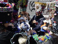 Dancers dressed in chinelos accompany residents of the town of Xoco in Coyoacan, Mexico City, on November 16, 2024, as they protest outside...