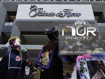 Dancers dressed in chinelos accompany residents of the town of Xoco in Coyoacan, Mexico City, on November 16, 2024, as they protest outside...