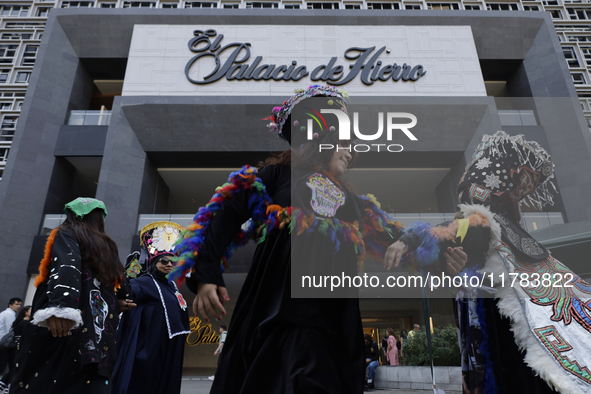 Dancers dressed in chinelos accompany residents of the town of Xoco in Coyoacan, Mexico City, on November 16, 2024, as they protest outside...