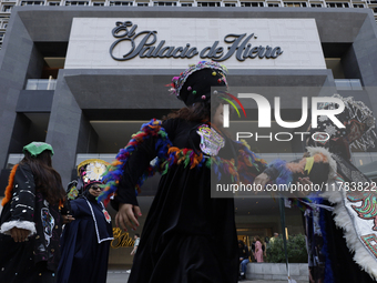 Dancers dressed in chinelos accompany residents of the town of Xoco in Coyoacan, Mexico City, on November 16, 2024, as they protest outside...