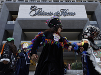 Dancers dressed in chinelos accompany residents of the town of Xoco in Coyoacan, Mexico City, on November 16, 2024, as they protest outside...