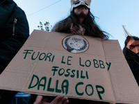 People wear animal masks and hold signs and banners as they participate in the street parade for the Climate Pride on November 16, 2024 in R...