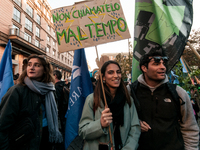 People wear animal masks and hold signs and banners as they participate in the street parade for the Climate Pride on November 16, 2024 in R...