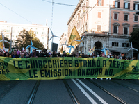 People wear animal masks and hold signs and banners as they participate in the street parade for the Climate Pride on November 16, 2024 in R...