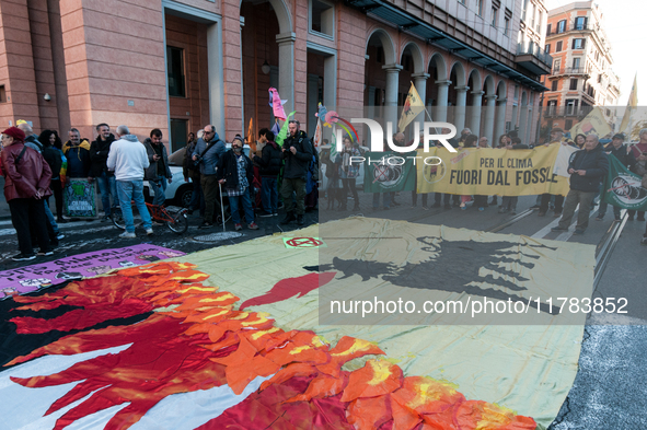 People wear animal masks and hold signs and banners as they participate in the street parade for the Climate Pride on November 16, 2024 in R...