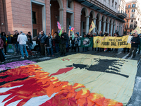 People wear animal masks and hold signs and banners as they participate in the street parade for the Climate Pride on November 16, 2024 in R...