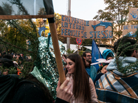 People wear animal masks and hold signs and banners as they participate in the street parade for the Climate Pride on November 16, 2024 in R...